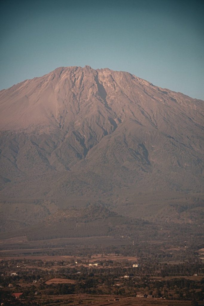 a large mountain with a very tall peak in the distance